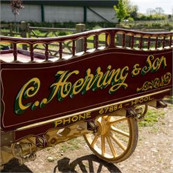 Advertising Trade Dray Wagon for C. Herring & Son, Hartlepool, Dated 1895 and Renovated 1975

An exceptionally decorative late Victorian horse drawn advertising trade dray, built by J. Herring of Hartlepool in 1895 and later renovated by C. Herring in 1975, as recorded by the painted inscription beneath the body. Finished in a striking cream and maroon livery with extensive hand painted signwriting, the wagon carries the name C. Herring & Son, Iron & Steel Processors, Hartlepool along its sides and rear panels. The wagon is fitted with a flat timber loading bed, twin shafts for a single horse, elegant spoked wooden wheels, iron bound tyres, rear headboard and traditional undercarriage with leaf spring suspension. Richly detailed scrollwork and lining throughout make this a particularly attractive example, suitable for collection, display, museum, promotional or coaching purposes.

Features

• Built by J. Herring, Hartlepool, 1895
• Renovated by C. Herring in 1975
• Original style hand painted advertising signwriting
• Flat timber loading platform
• Raised rear headboard with decorative pierced gallery
• Twin shafts for a single horse
• Wooden spoked wheels with iron tyres
• Traditional leaf spring suspension
• Extensive decorative lining and scrollwork throughout
• Attractive cream and maroon colour scheme
• Suitable for private collection, museum or display use

Dimensions:
Overall length: 560 cm
Body length: 300 cm
Width: 158 cm
Height: 150 cm

Wheel Diameters:
Front wheels: 76 cm
Rear wheels: 86 cm