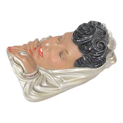 Art Deco style plaster wall mask, depicting a woman in a silver headdress with red lips and nails, H33cm