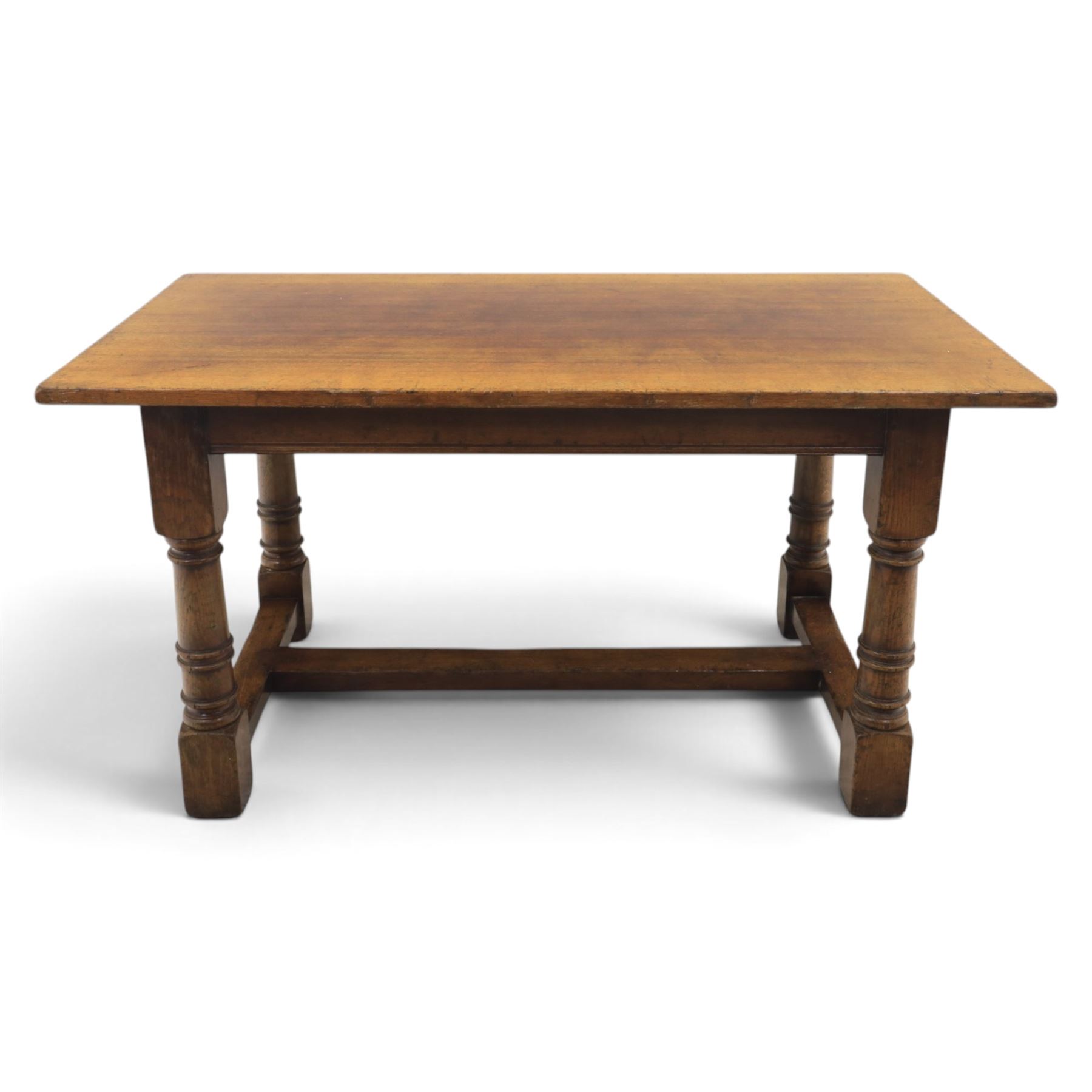 Titchmarsh & Goodwin style solid oak refectory table, rectangular top raised on block and turned supports united by a full length undertier