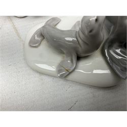 Seven Lladro figures, comprising Playful Puppy no 9135, Platero and Marcelino/Boy Hugging Donkey no 1181, Mini Seal Family no 5318, Attentive Polar Bear no 1207, Seated Polar Bear no1209, Eskimo Boy with Pet no 5238 and Girl with Geese no 1035, together with Nao goose