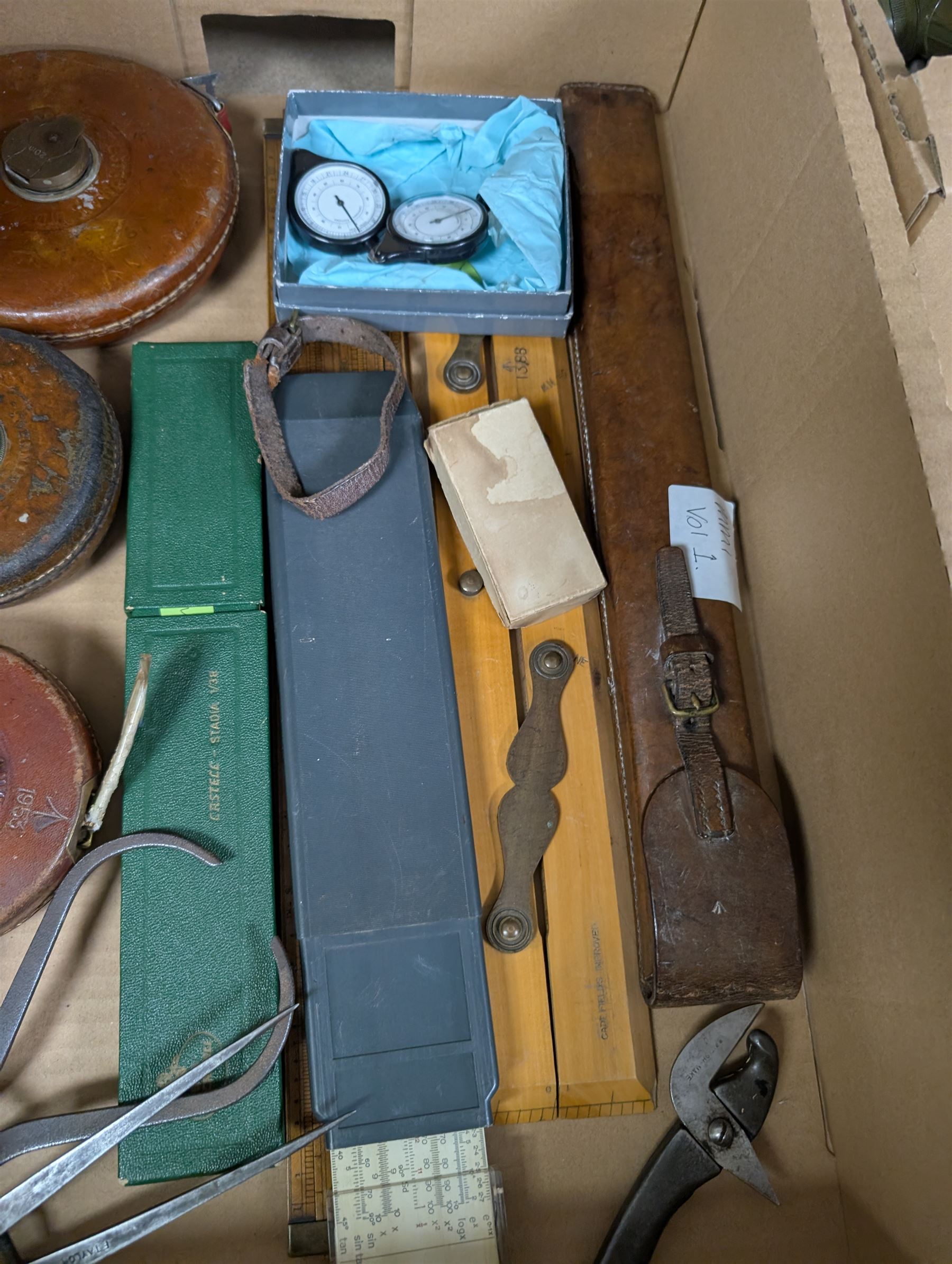 Three Rabone tape measures in leather cases, one with broad arrow, three map wheels, pair of Moore & Wright calipers, W Harling alidade in Whippy leather case with broad arrow and a collection of slide rules