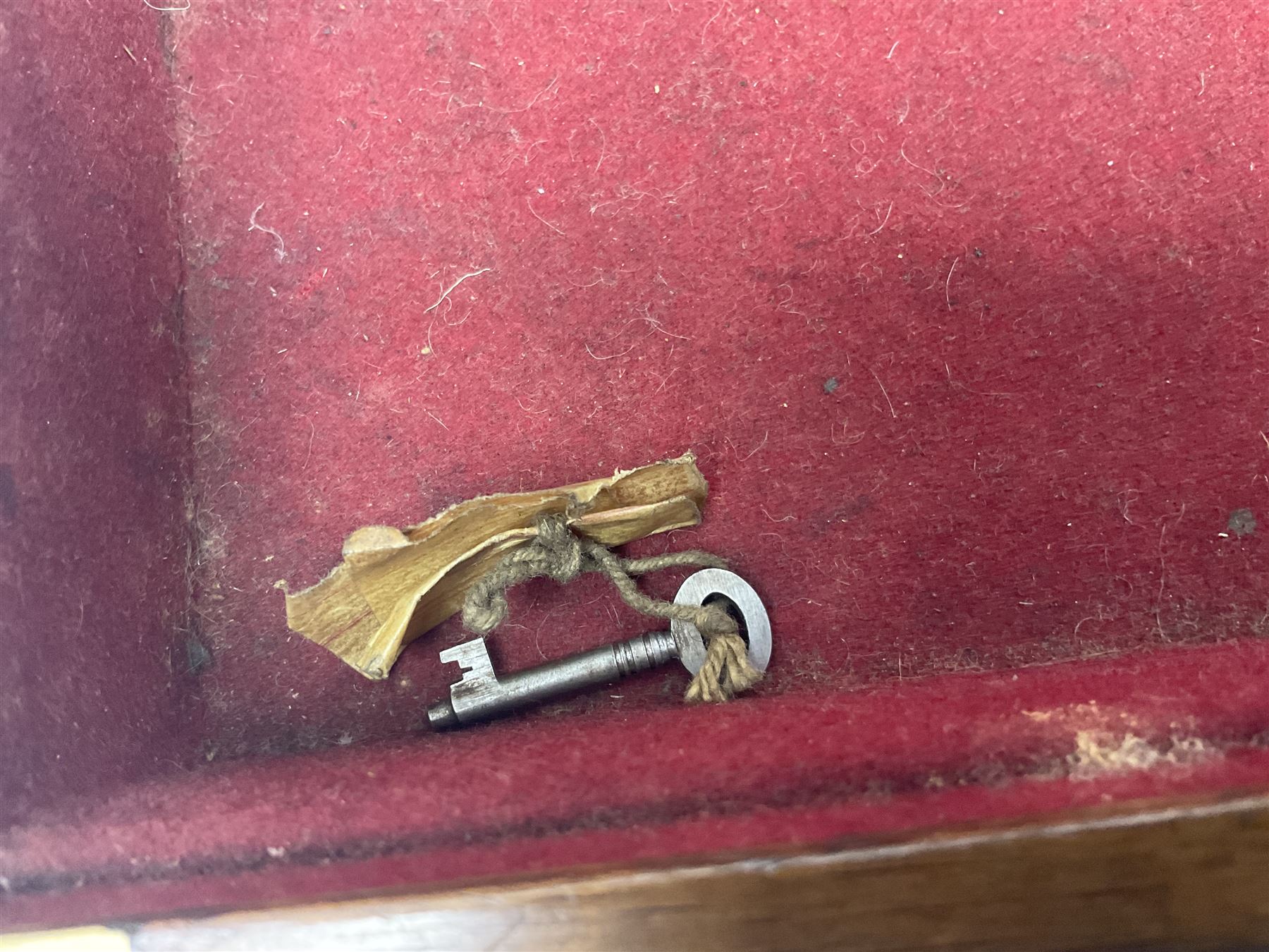 Leather shotgun case, the red baize lined interior with the trade labels of Westley Richards & Co., London, a brass plaque inscribed 'T Nevin, Mirfield, Yorkshire' to cover, with key, case to fit barrel 76cm (30 inches)  
