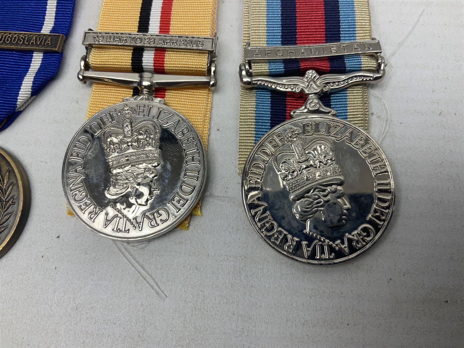 NATO Service Medal with clasp for Former Yugoslavia; together with three copy medals - Iraq Medal with clasp for 19 Mar to 28 Apr 2003 and unfitted rosette; Operational Service Medal with Afghanistan clasp; and QEII Golden Jubilee 2002 medal; all with ribbons (4)