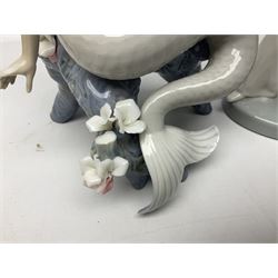 Four Lladro figures, comprising Touch of Class no 5377, Boy Student no 4517, Ocean Beauty no 5785 and Carnival Couple no 4882, largest example H45cm