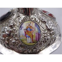 German silver chalice, the bowl, stem and foot each with 19th century repousse and chased decoration depicting putti masks, C scrolls and flowers, set with two hand painted porcelain roundels, possibly Berlin, and six later applied enamel roundels, each depicting religious scenes, the gilded bowl upon knopped stem and spreading octofoil foot, the base with marks for Munich, c.1695 and maker's mark FK