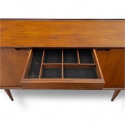Richard Hornby for Fyne Ladye - mid-20th century afromosia teak sideboard, retailed by Heals of London, rectangular form, with low profile carved gallery lip, above three central drawers with ribbed drawer fronts, flanked by two cupboards with vertically grained doors and recessed pull handles, with streamlined moulded edges and sides, raised on tapered slender legs 