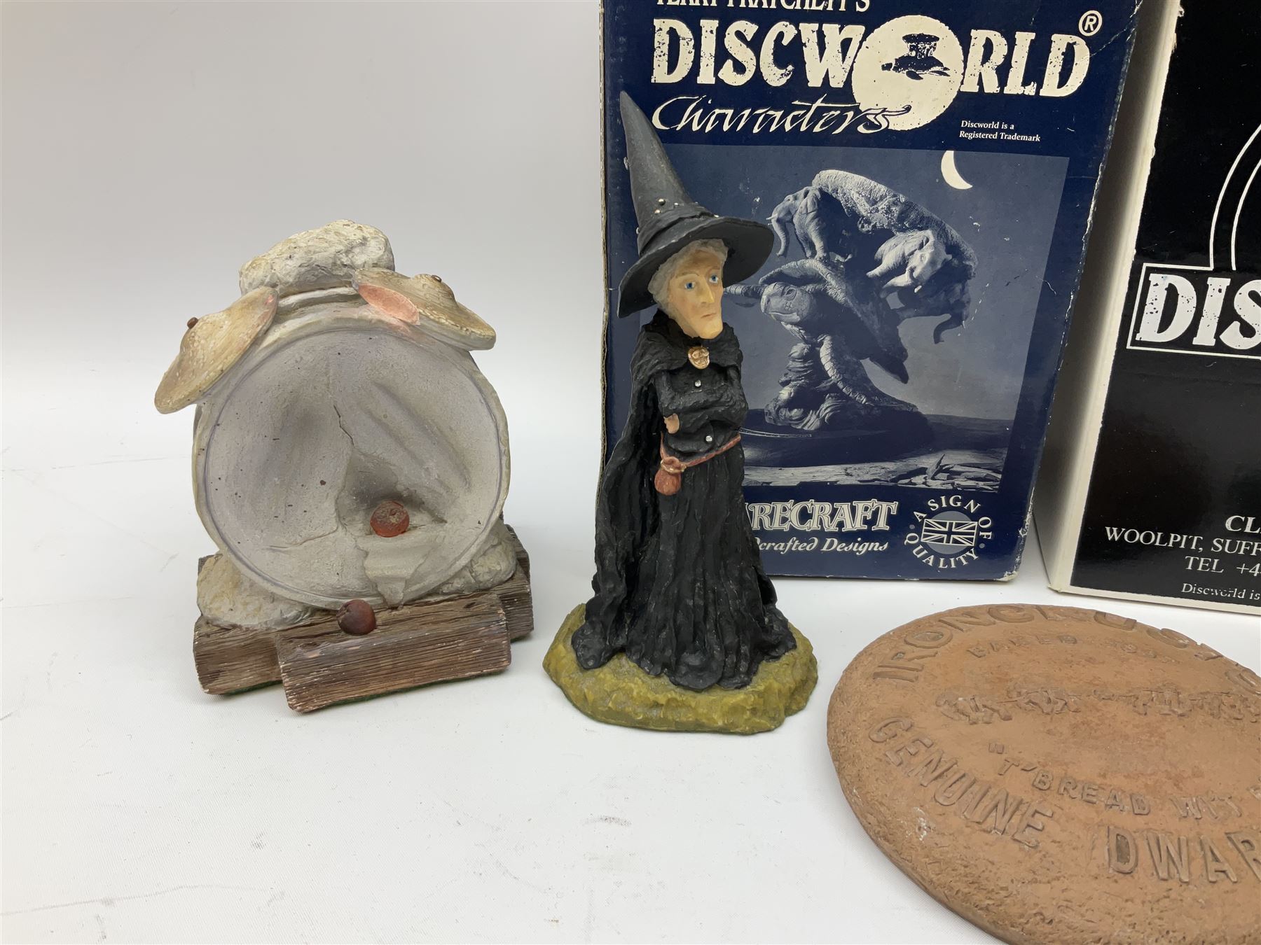 Terry Pratchett Discworld figures, designed by Clarecraft, comprising Lias Bluestone DW82, Hogfather DW72, Granny Weatherwax, boxed, DW06, Ridcully DW61and 'Ironcrust's genuine dwarf bread'.