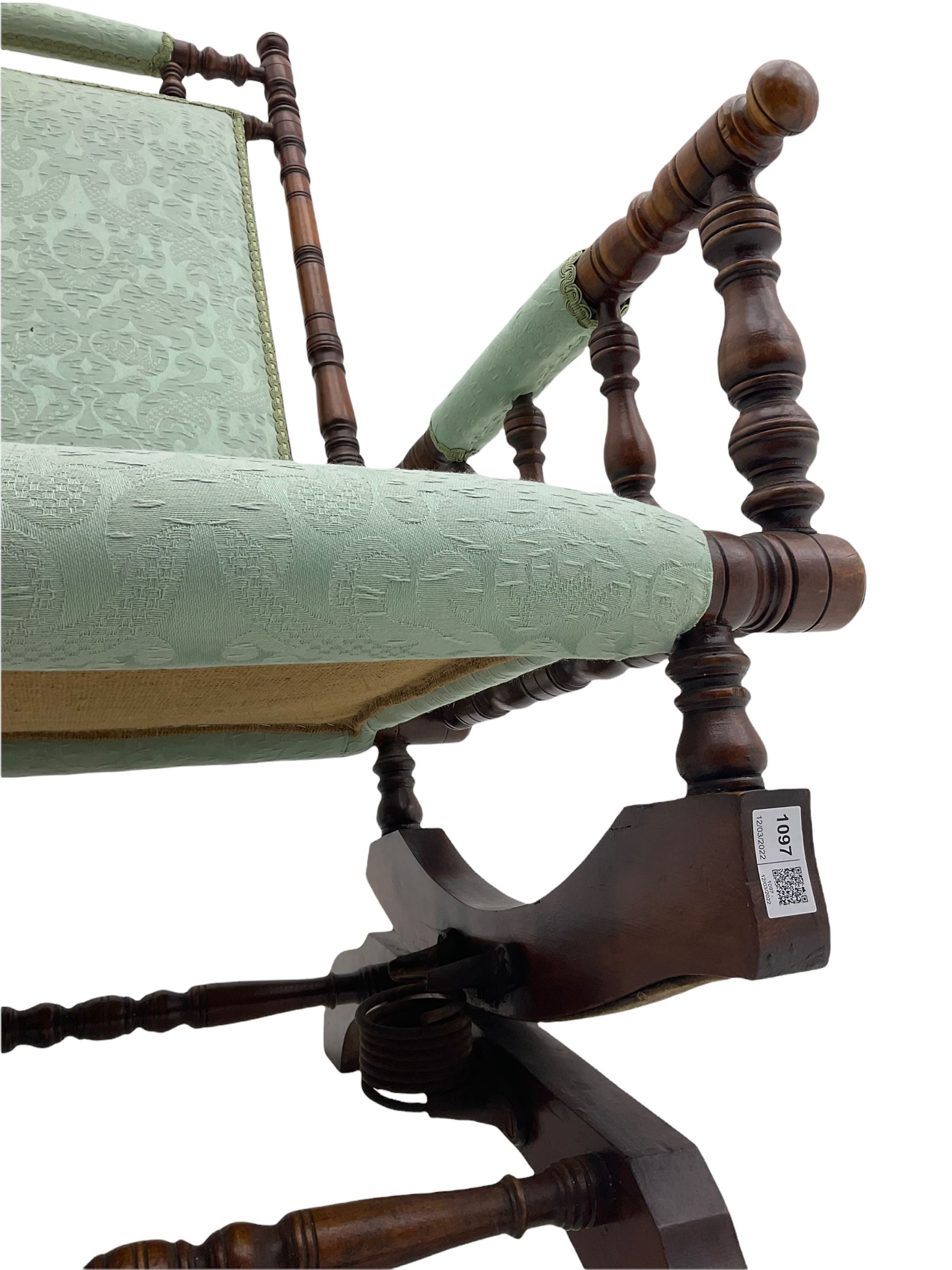 Early 20th century walnut framed American rocking chair, upholstered seat, back and arms