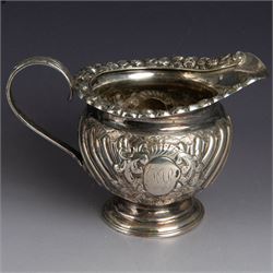 Victorian silver four piece tea service, comprising hot water pot, teapot, milk jug and sugar bowl, of circular part fluted bellied form, with embossed and engraved floral decoration, engraved with initials to body, the teapot and hot water pot with wooden handles and finials, hallmarked Z Barraclough & Sons, Sheffield 1898