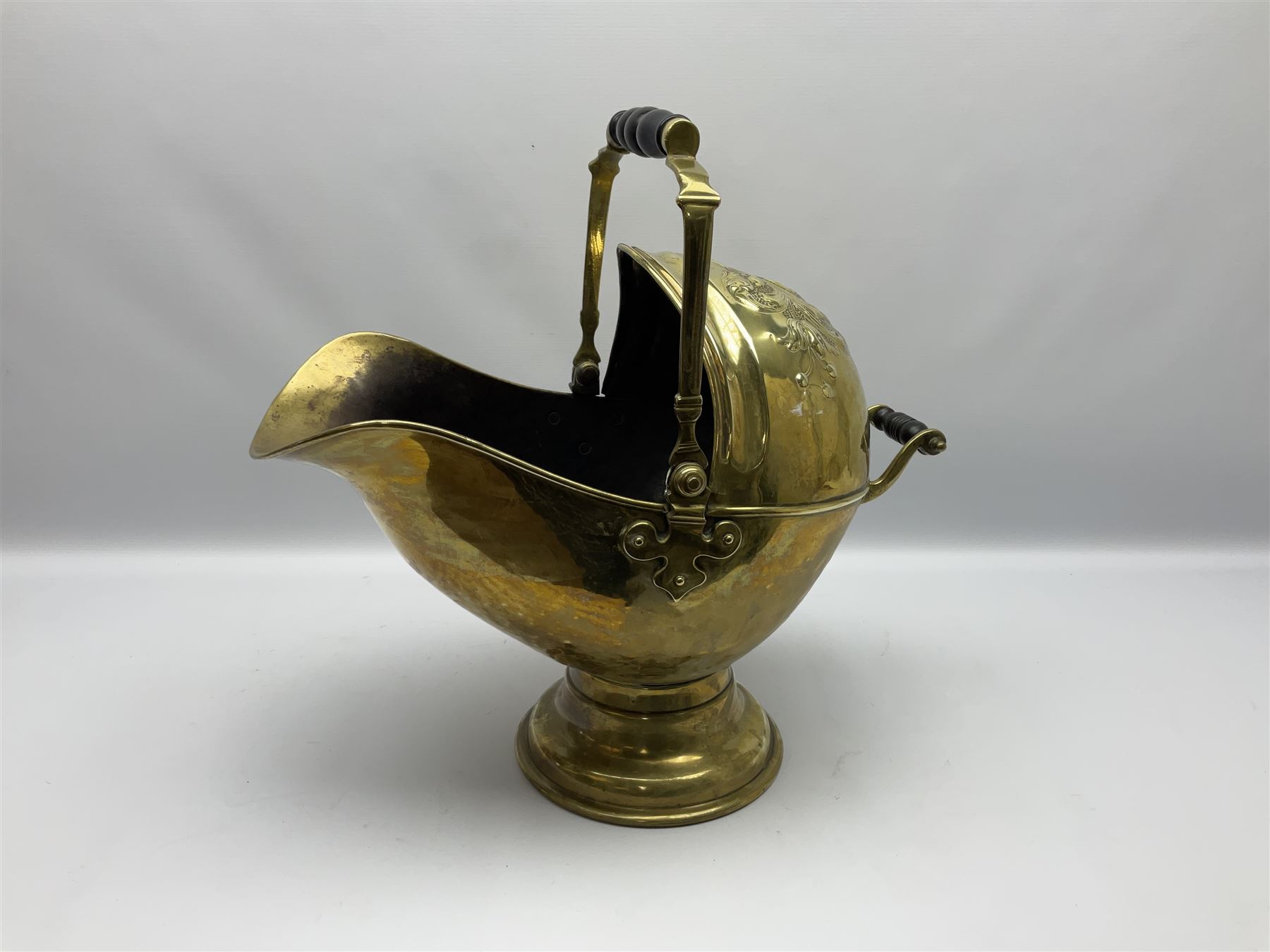 Victorian brass coal scuttle, of helmet form with turned ebonised handles, H48cm