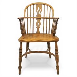 Late 20th century elm and beech low back country Windsor armchair, the arched hoop back with central pierced splat and turned spindles, shaped arm rail on turned supports, saddle seat, raised on turned legs united by a crinoline stretcher