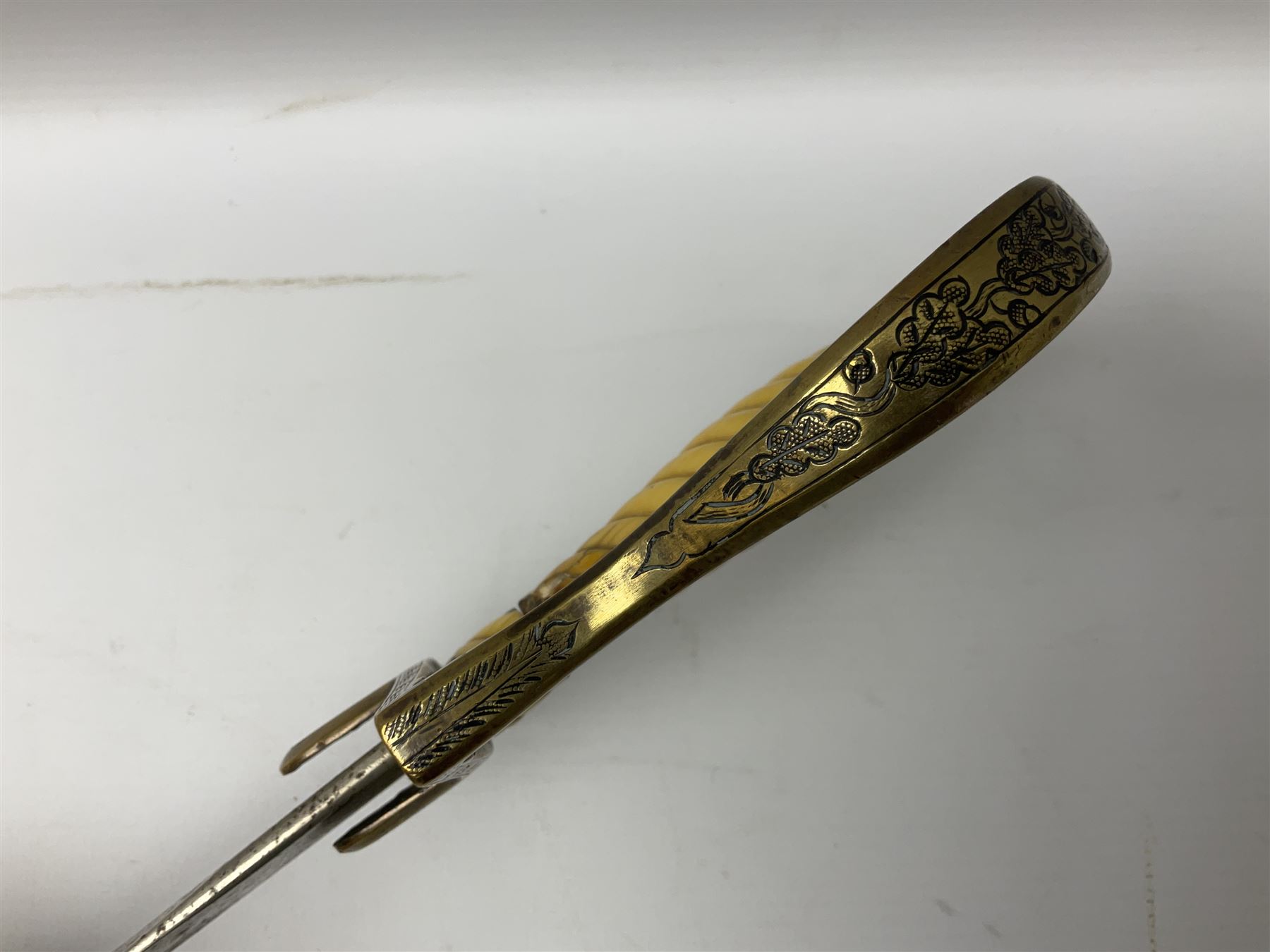 1900-1918 German Imperial NCO sabre with WW2 modifications of Wehrmacht insignia to the langet, 79cm slightly curving fullered blade and brass hilt, the knucklebow chased with oak leaves and acorns L90.5cm overall
This item has been registered for sale under Section 10 of the APHA Ivory Act 