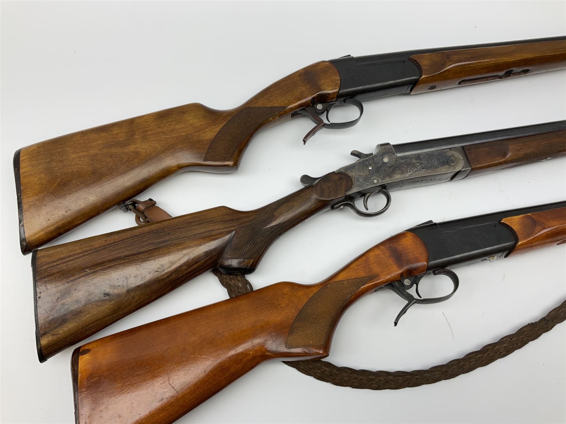 Three 12-bore single barrel sporting guns - Russian Baikal with 72.5cm barrel and underlever opening, serial no.Y17440, L114cm overall; Russian Baikal with 72.5cm barrel and underlever opening, serial no.A23484 L114cm overall; and Spanish with 76.5cm barrel and top lever opening, serial no.38996MU L118.5cm overall (3) SHOTGUN CERTIFICATE REQUIRED