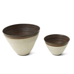 Sarah Butler and Martin Clark: Three works, comprising two bowls and a sleeve vase, each with incised potters mark to bases, and one with Heals mark, sleeve vase H24cm (3)