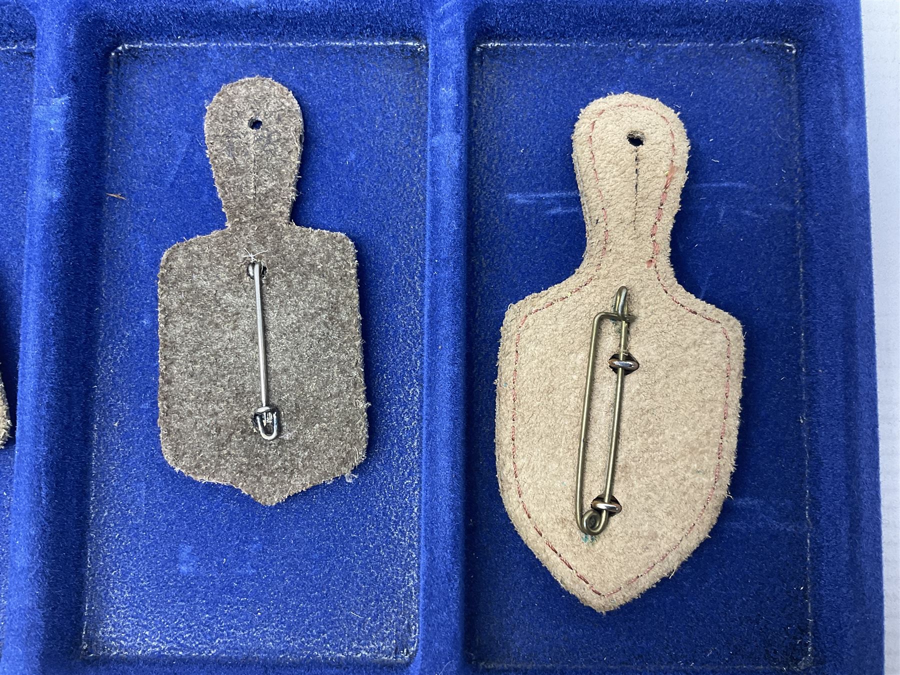 Twelve French military metal badges mounted on leather fobs including Legion, Artillery, Parachutist, Air Force, Infantry etc