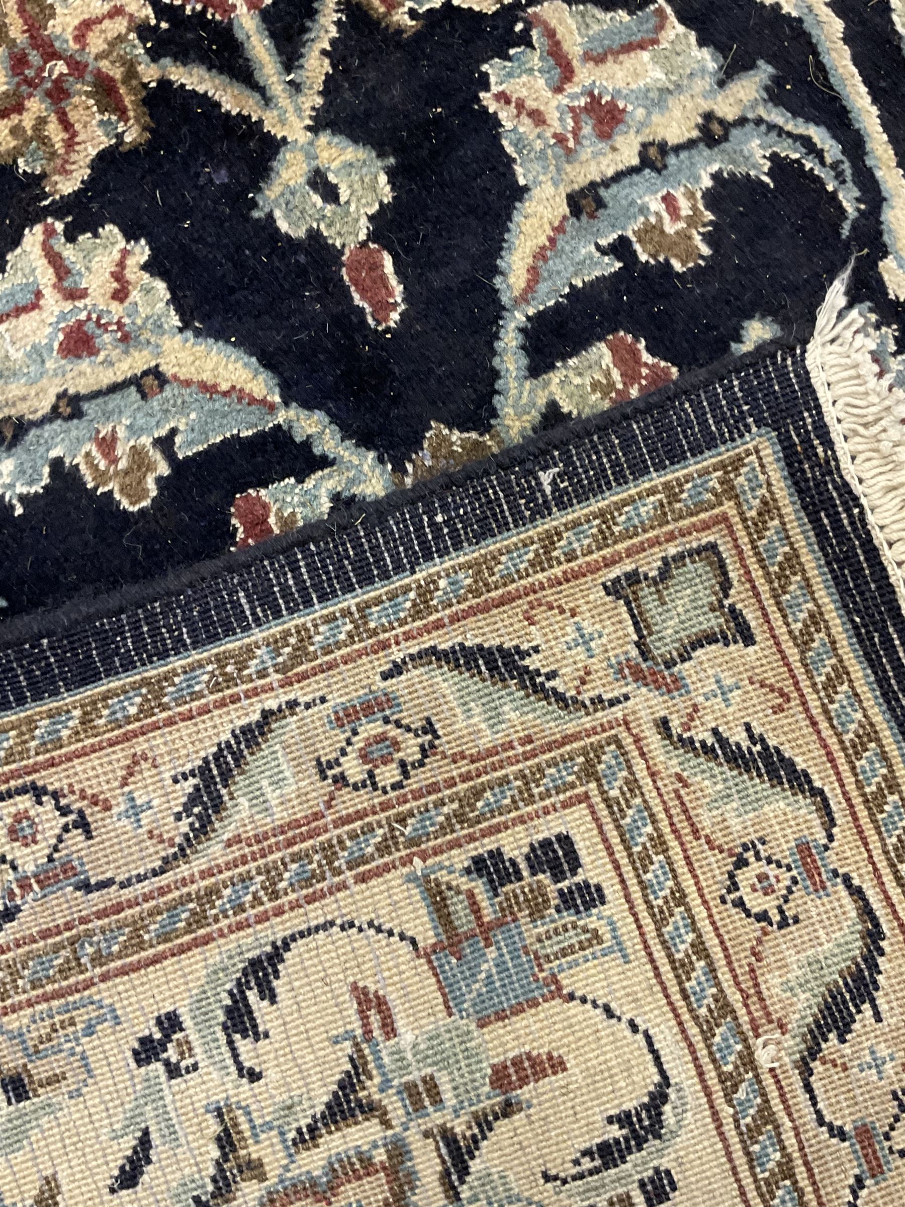 Central Persian part silk indigo ground Nain carpet, the field decorated with interlacing leafy branches and stylised plant motifs, scrolling design border within guard stripes 