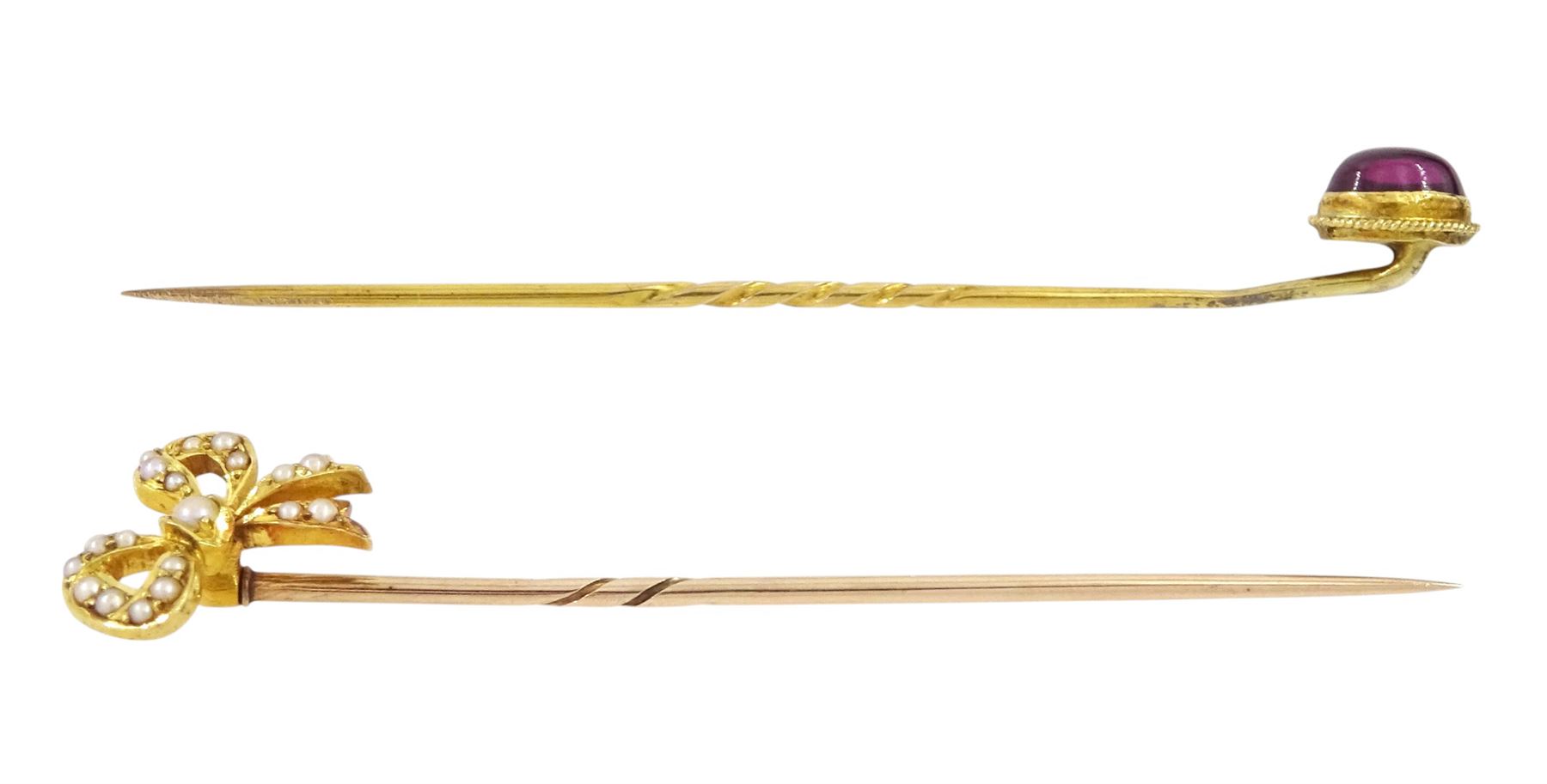 Two early 20th century gold stick pins, including a seed pearl set ribbon bow and cabochon garnet, one boxed