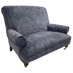 Traditional shape hardwood framed two-seat sofa, high back over deep seat and rolled arms, on turned front feet with brass cups and castors, upholstered by Plumbs in blue fabric