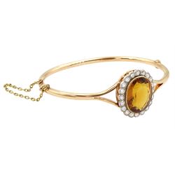 Early 20th century 15ct rose gold oval citrine and milgrain set old cut diamond hinged bangle, total diamond weight approx 1.10 carat