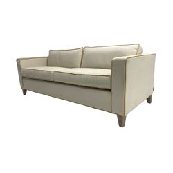 Neptune - pair three seat 'Shoreditch' sofas,  upholstered in cream fabric with yellow stringing