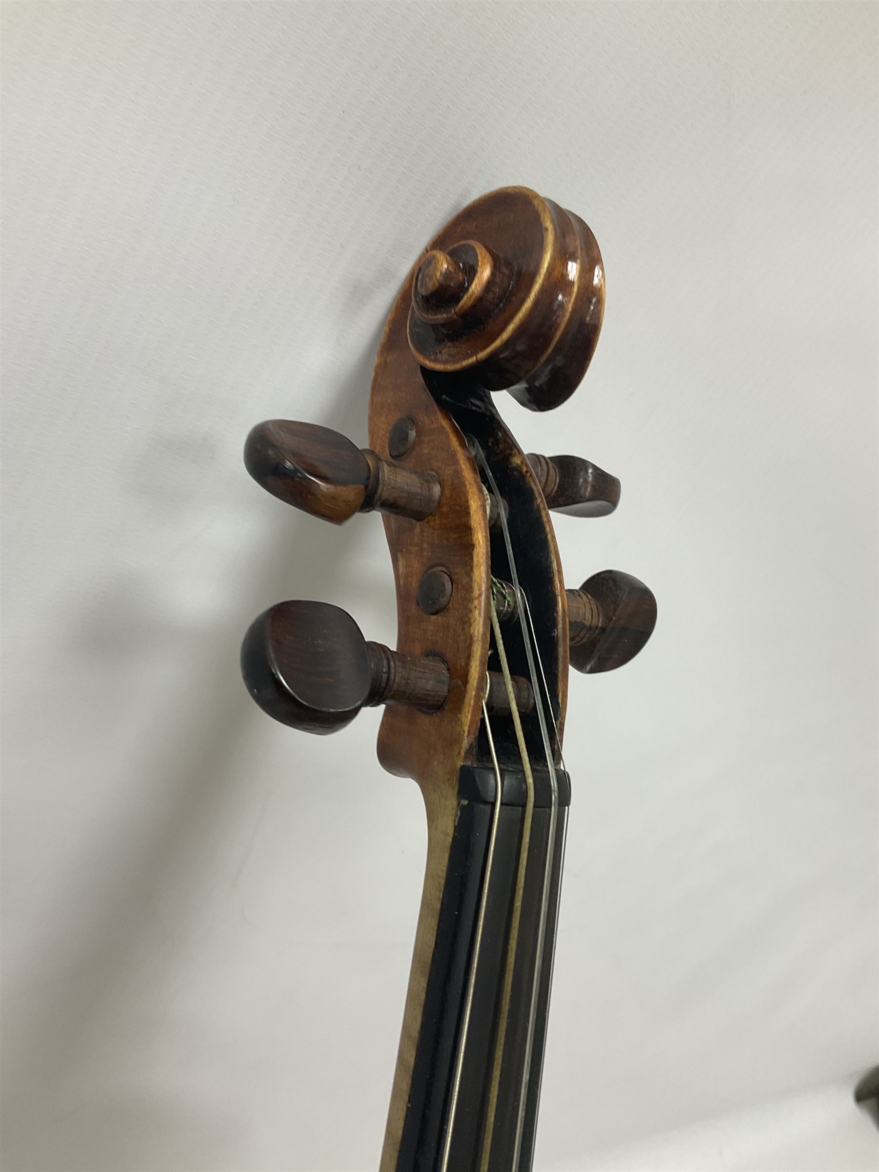 19th century full sized violin in a later hard case, decorative mother of pearl inlay to the tail piece Overall length 60cm No bow