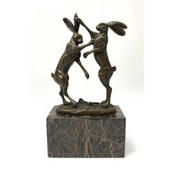 A bronze figure group, modelled as two male hares boxing, upon a naturalistic base signed Nick and with foundry mark, raised upon a rectangular marble base, overall H24cm.