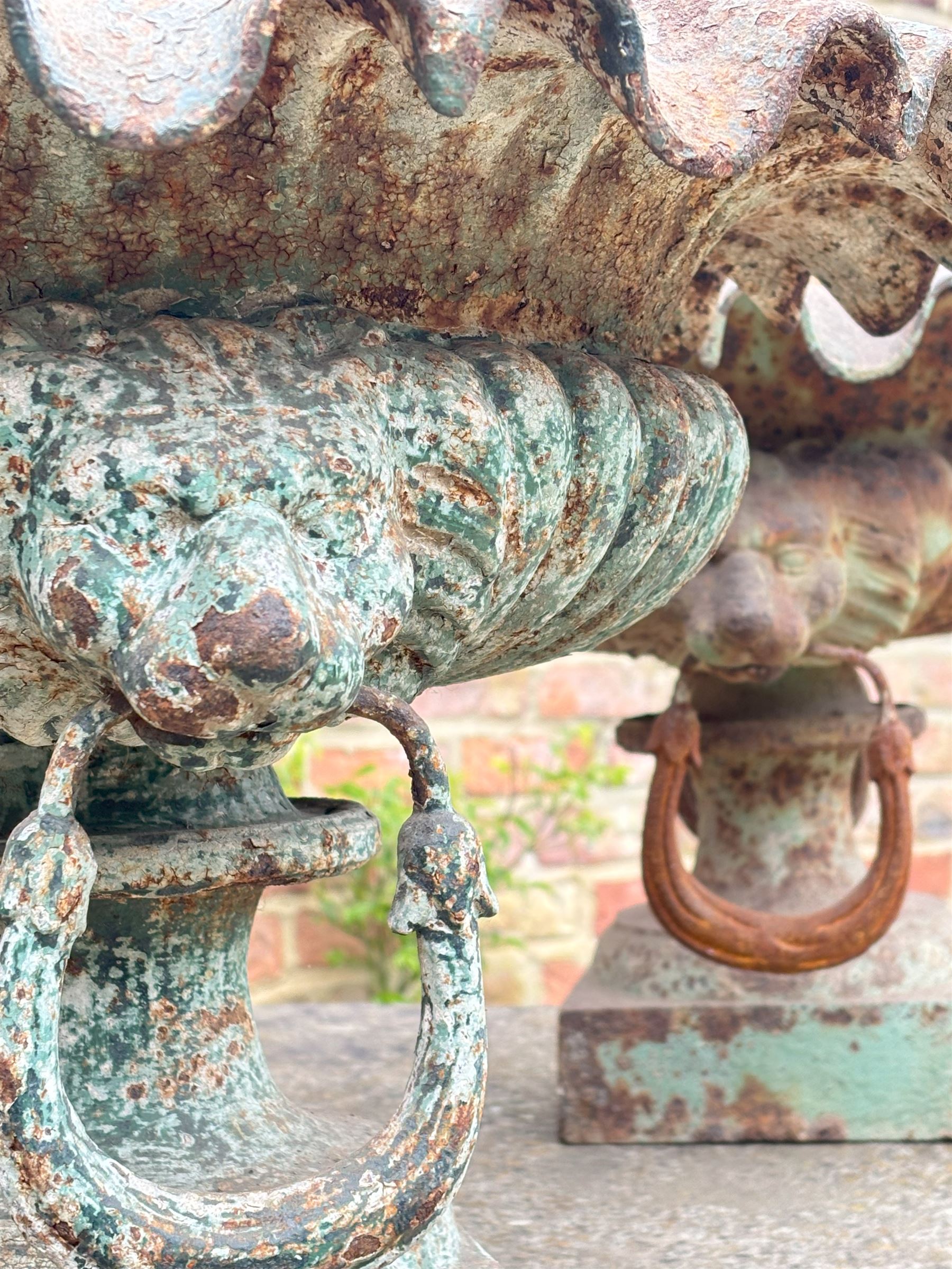 Pair of French cast iron garden urns, each with scalloped edge above lion mask and loop handles, on a square base. H36cm, D73cm.  - COLLECTION BY APPOINTMENT FROM: The White House, Thirsk Road, Easingwold, York, YO61 3NF - CALL 01723 507111 TO ARRANGE