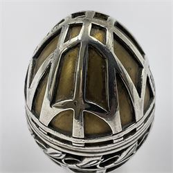 Modern silver limited edition Easter egg, no. 70/500, the gilded body decorated in relief with silver latticework and a band of flower heads, the detachable cover opening to reveal a gilt interior, each hallmarked St James House Company, London 1978, H5.5cm