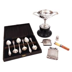 Group of silver, comprising 1930s silver trophy, with angular twin handles and engraved body, upon ebonised wooden base, silver mounted cheroot holder, thimble, 'The Classic' lighter, a cased set of coffee spoons, and a vesta case, all hallmarked with various dates and makers, trophy H11.5cm