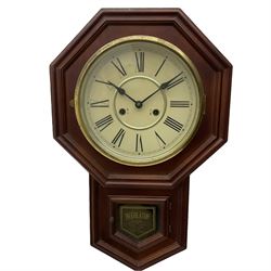 A mahogany effect American early 20th century “regulator” wall clock with an octagonal wooden dial surround and 10” circular dial, Roman numerals and minute track with steel spade hands, spun brass bezel and pendulum viewing door, eight day striking movement, striking the hours on a gong. With pendulum.  
