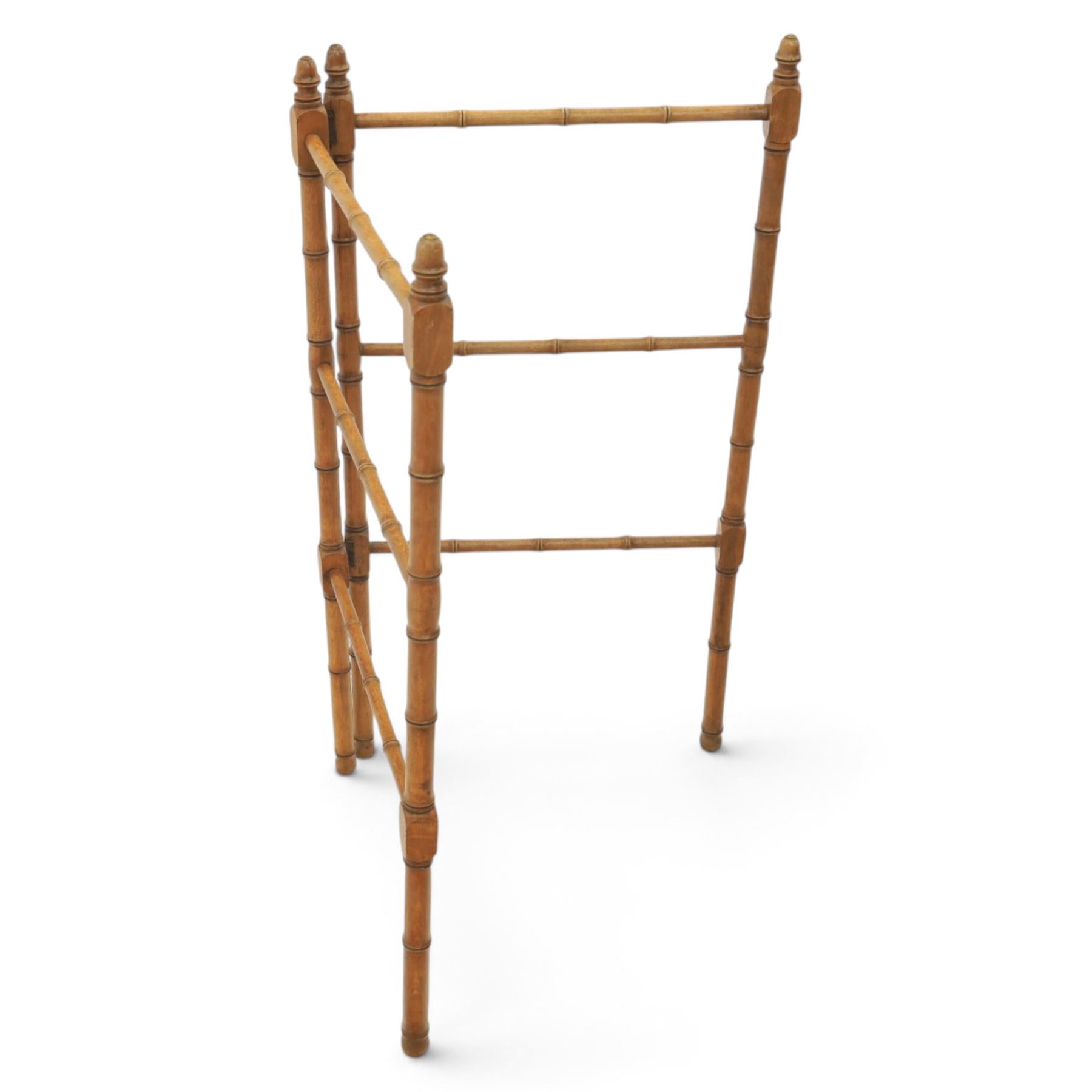 Victorian simulated bamboo two section towel rail, with turned brass capped finials, with three rails for hanging, hinged at one side