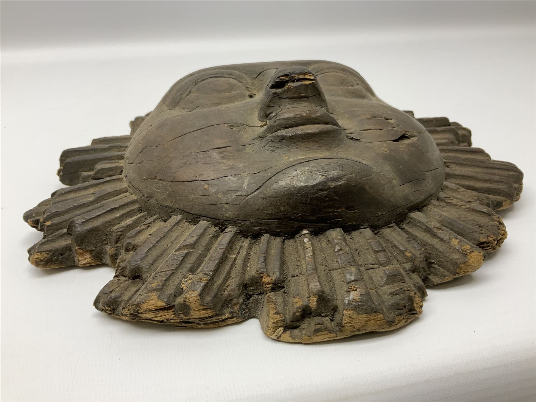 Carved pine mask of the sun, probably late 17th/early 18th century, originally a cresting, bearing Christie's lot labels, D20cm

Provenance 
Lot 161, Christopher Howe - The First Twenty Years, Christie's. 24th March 2004
