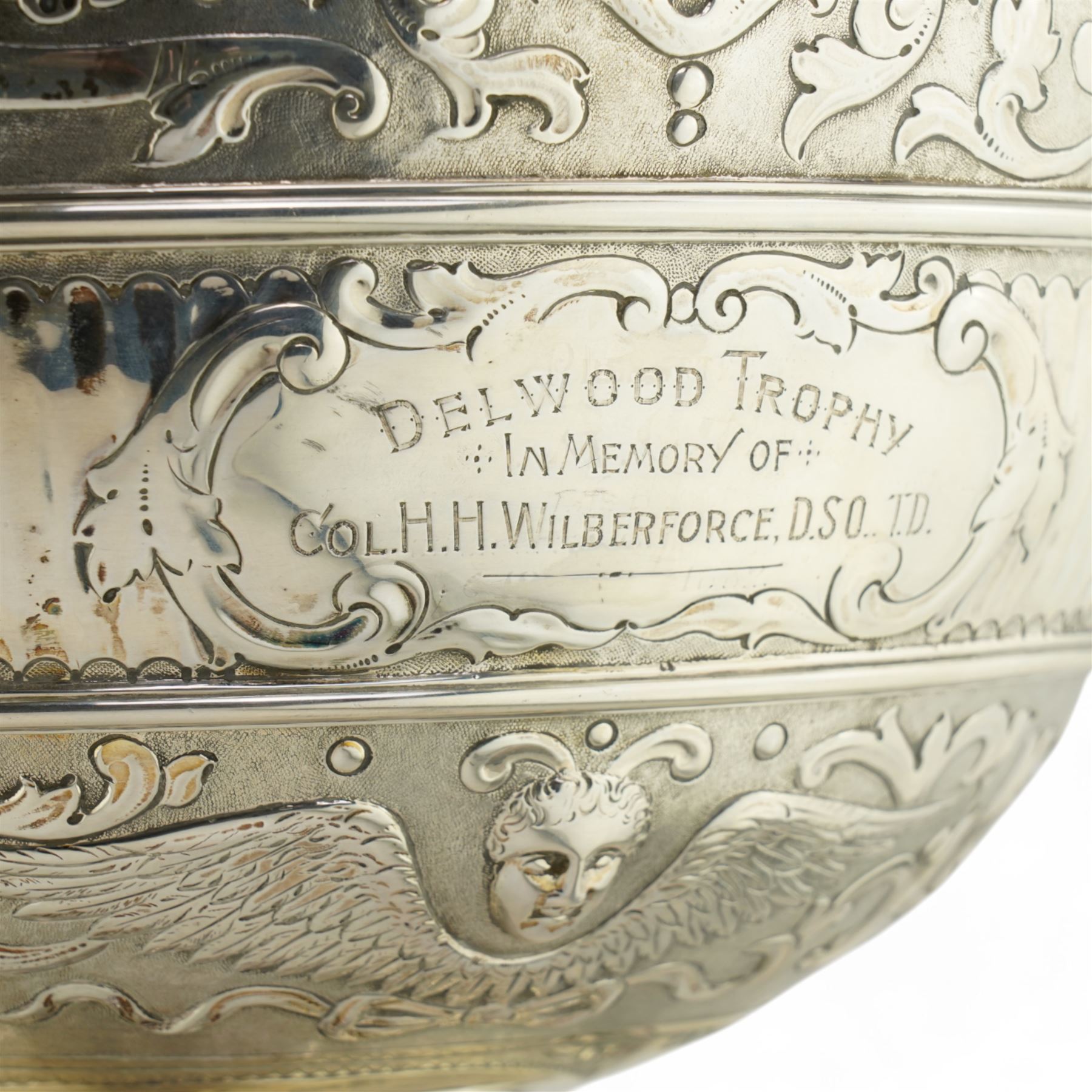 'Delwood Trophy in Memory of Col. H.H. Wilberforce' - A large Victorian silver rose bowl embossed with masks, wings, scrolls etc on a short pedestal foot D29cm London 1882 Maker Walter & John Barnard 