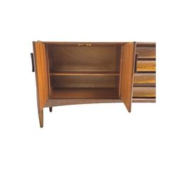 Elliots of Newbury (EoN) - mid-20th century teak sideboard, fitted with four central doors flanked by fall-front cupboard and a double cupboard, each with concave wooden handles
