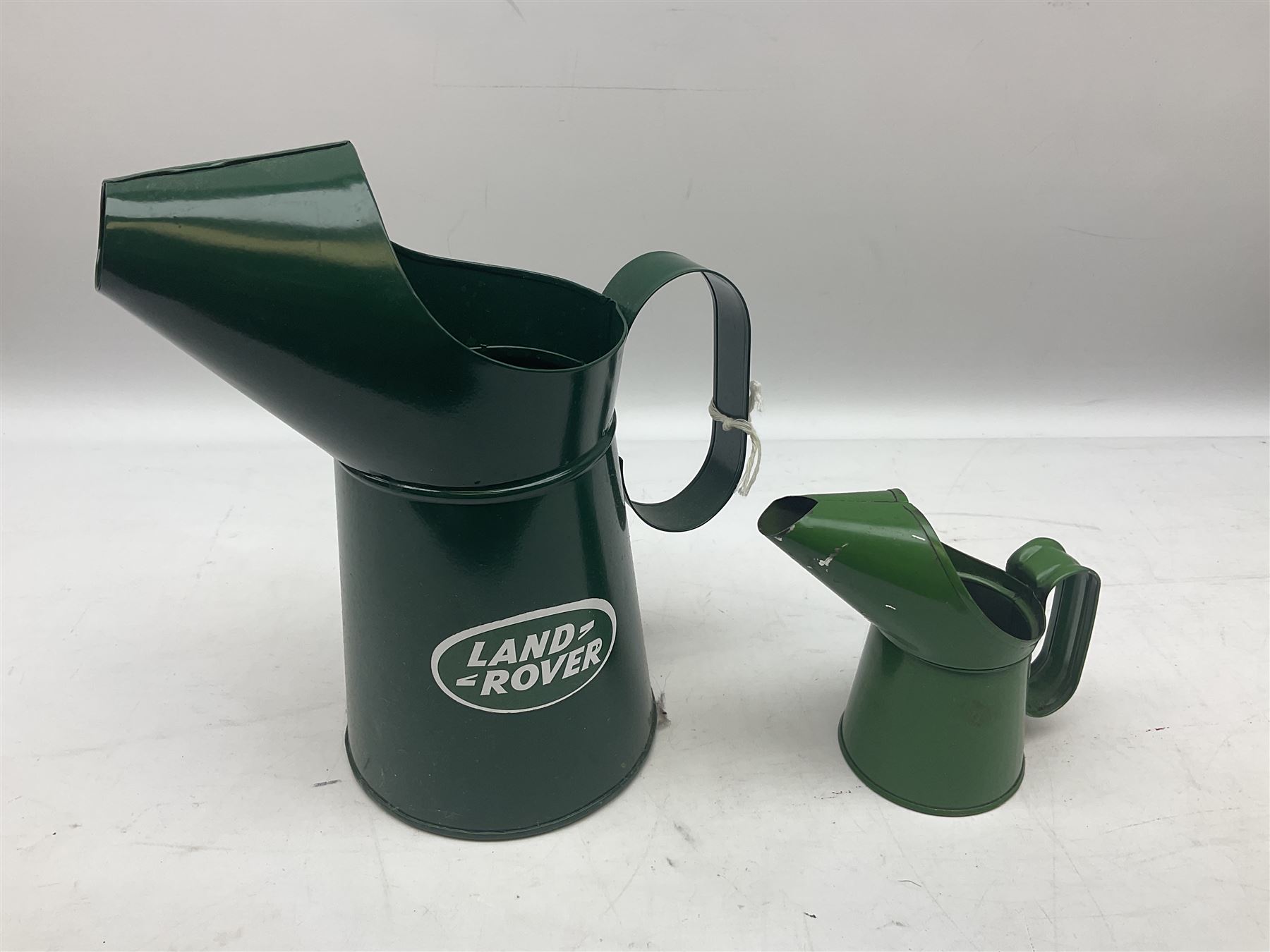 Bugatti cast iron sign with a red background, Shell Oil cast iron sign with gold background, together with Land Rover oil can, motorist warning lamp & torch tool kit and other motoring items 