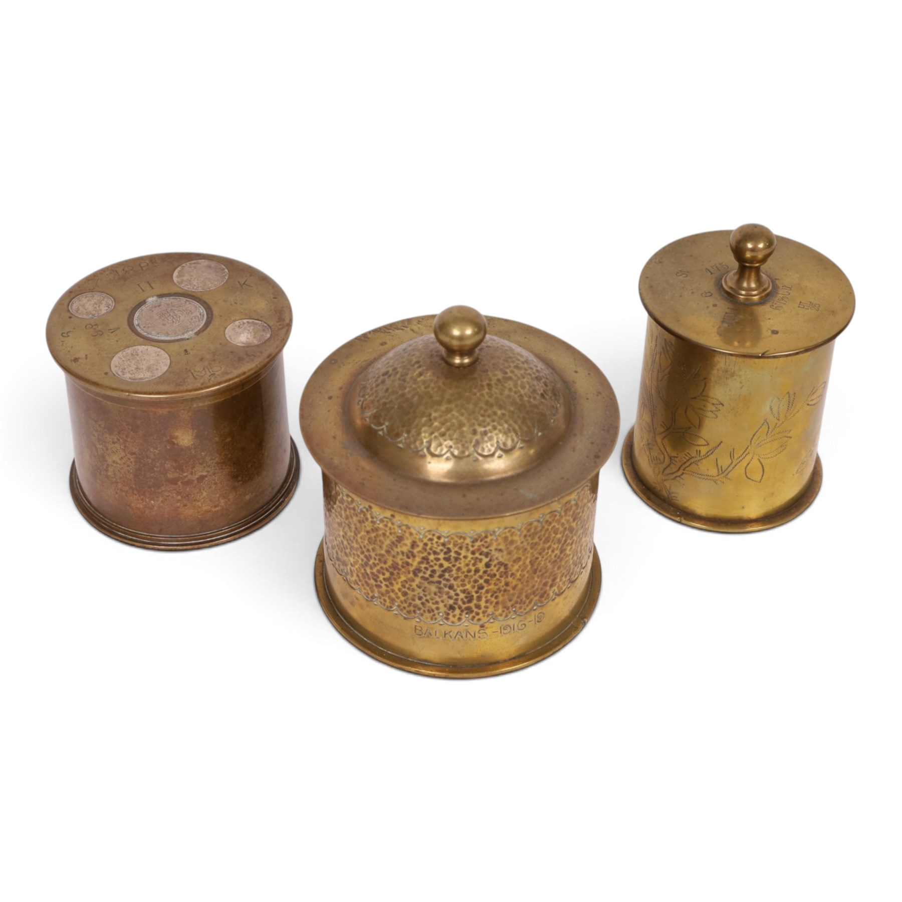 Three WWI trench art tobacco jars including an example with the lid embedded with silver rupees, largest H15cm 