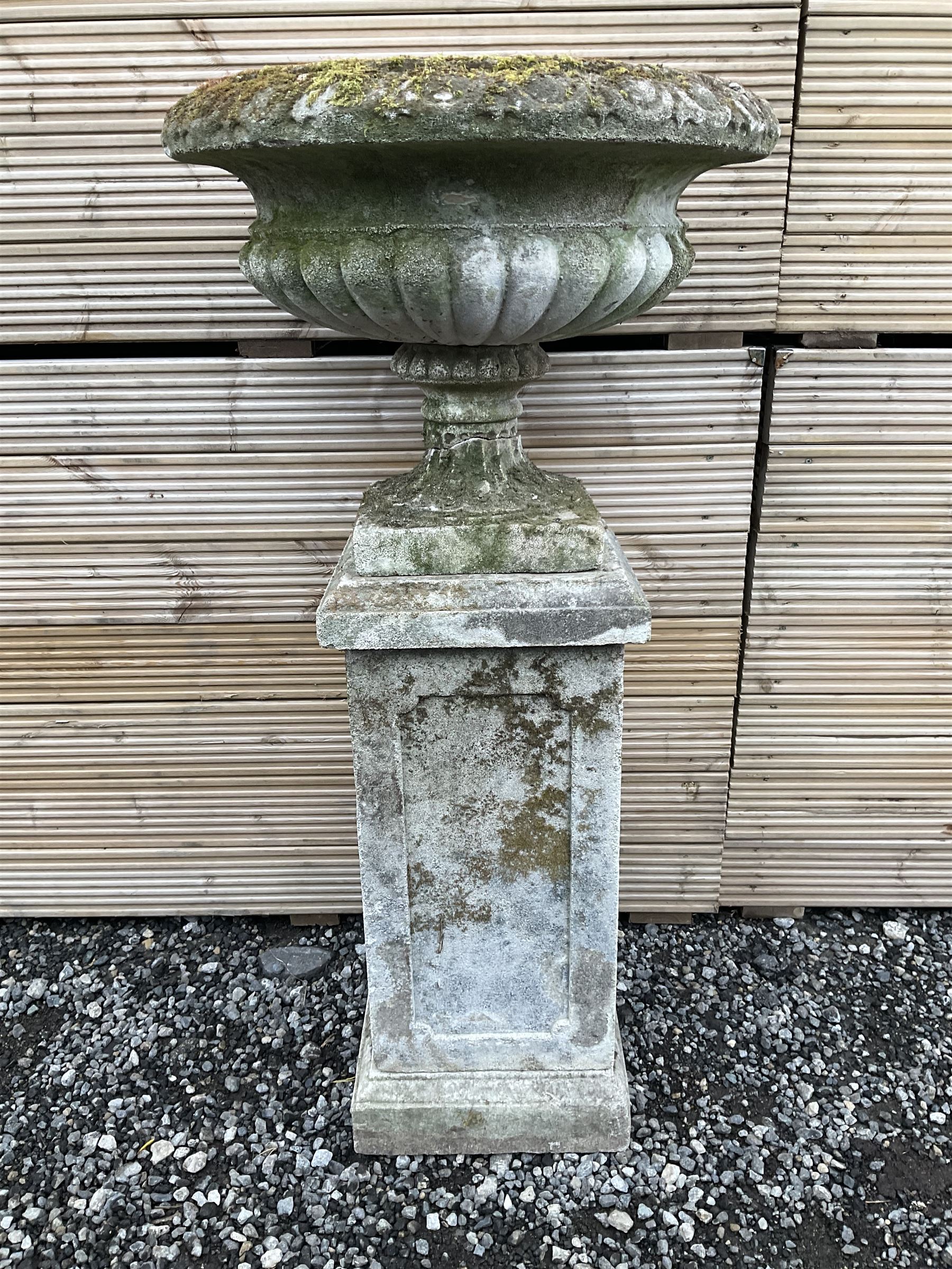 Cast stone urn on plinth, on tall square plinth - THIS LOT IS TO BE COLLECTED BY APPOINTMENT FROM DUGGLEBY STORAGE, GREAT HILL, EASTFIELD, SCARBOROUGH, YO11 3TX