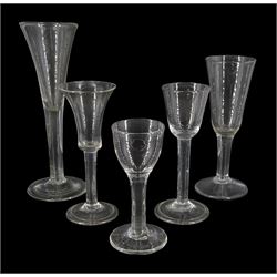 Five 18th century drinking glasses, of various form, the trumpet, funnel, rounded funnel and bell shaped bowls upon a plain stems and conical feet, two folded, tallest H21.5cm, smallest H13cm