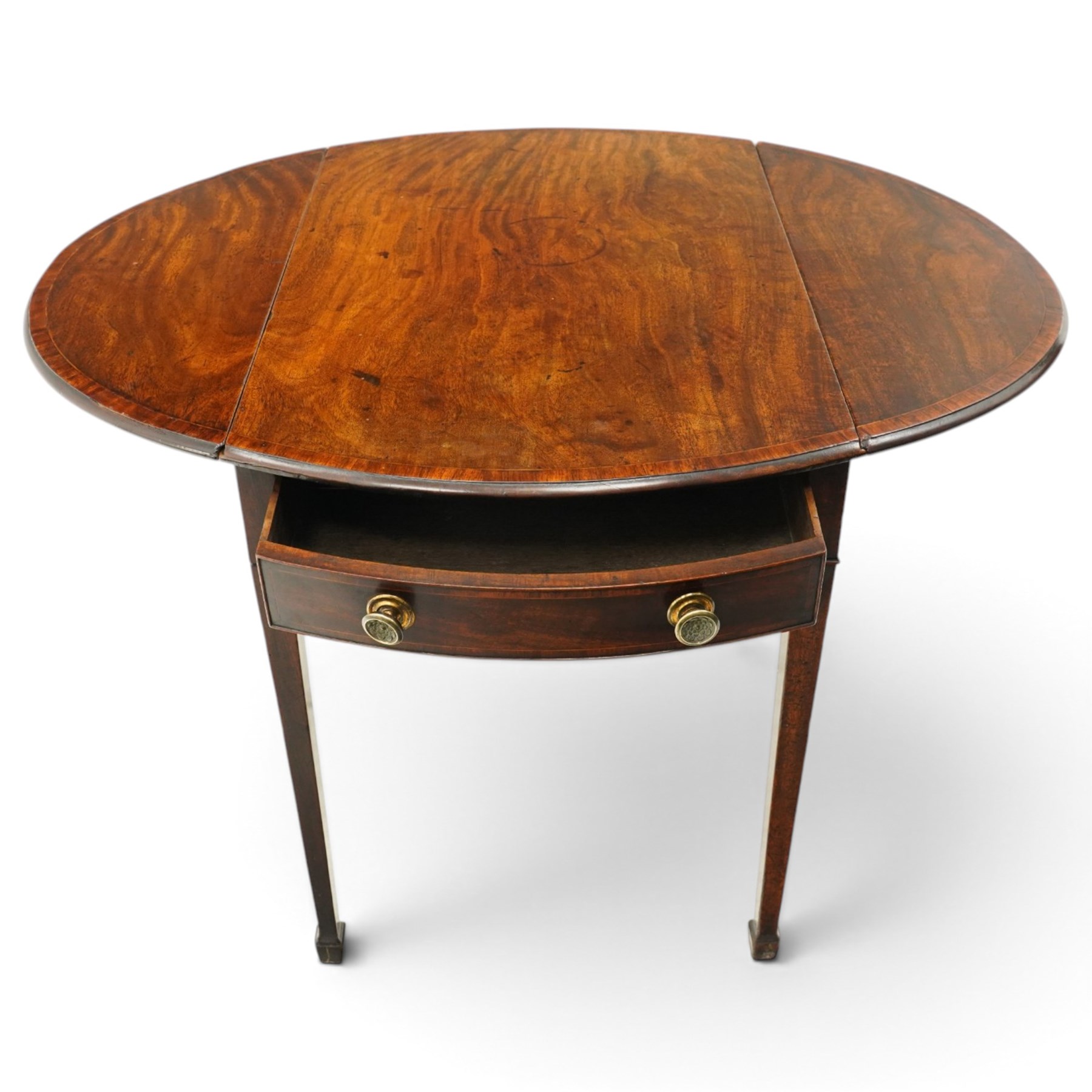 Small early 19th century George III mahogany Pembroke table of small proportions, the oval drop-leaf top with mahogany banding, fitted with twin opposing bow-fronted frieze drawers with brass pull handles, on square-tapering supports with spade feet