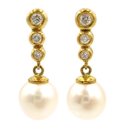  Pair of 18ct gold graduating three stone diamond and pearl pendant ear-rings, stamped 750  