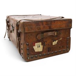 19th century leather trunk, featuring brass lock, with leather anchoring straps around the body, with leather handles
