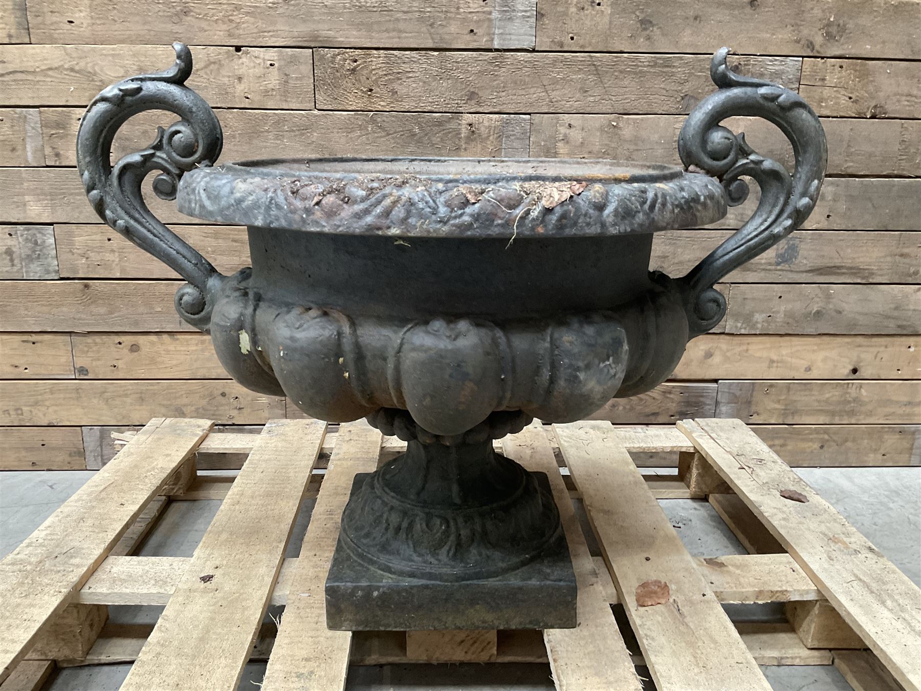 Victorian design ornate cast iron centrepiece urn, featuring two handles, raised on footed base