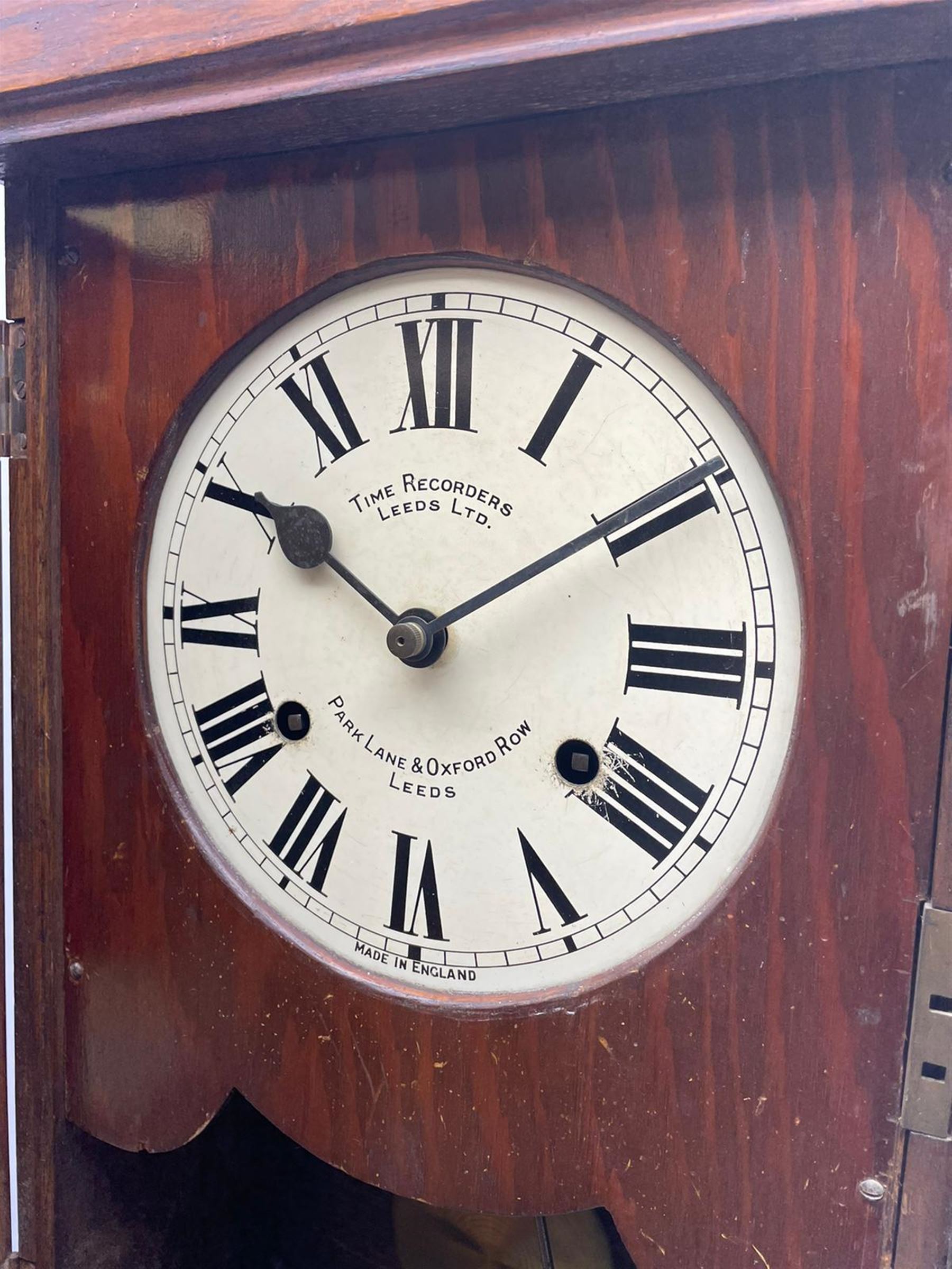 Early 20th century oak cased time recorder, circular Roman dial signed 'Time Recorders Leeds Ltd. Park Lane & Oxford Row Leeds', the glazed door signed 'National Time Recorder Co Ltd. London...'