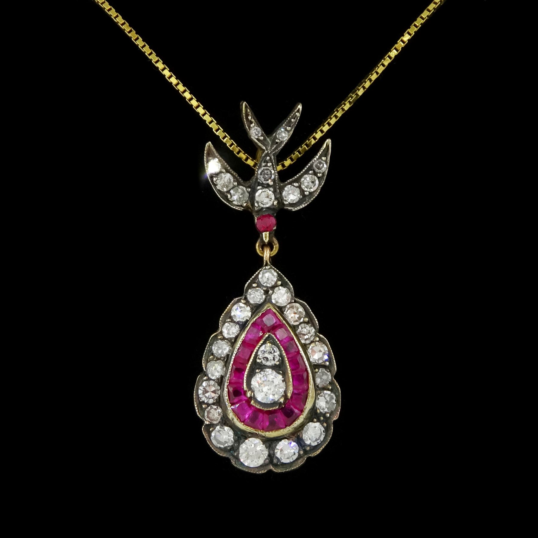 Gold and gold-plated diamond and ruby pendant necklace, the pear shaped pendant, milgrain set with round brilliant cut and single cut diamonds and calibre cut rubies, suspending from a ruby and diamond swallow bail, on a silver-gilt chain, total ruby weight 0.35 carat, total diamond weight 0.60 carat, with World Gemological Institute Report 