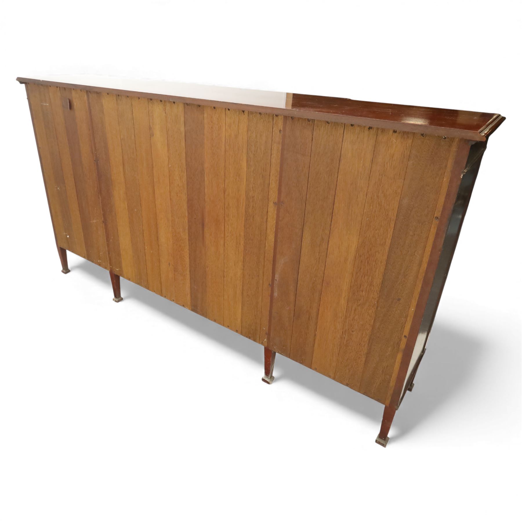 Early 20th century mahogany breakfront bookcase cabinet, the moulded rectangular top above a central pair of astragal glazed doors with arched glazing bars enclosing shelving, flanked by open book shelves, raised on square tapering supports with block feet