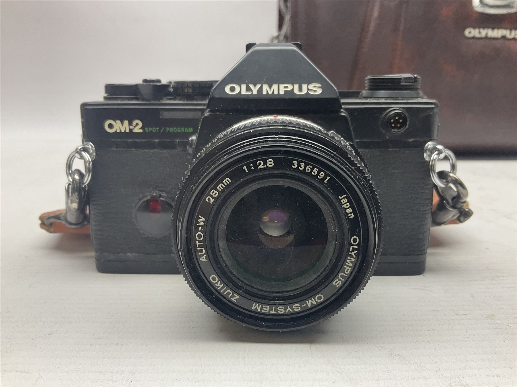 Olympus OM-2 camera body, serial no 1117526, with Olympus OM-System Zuiko Auto-W 28mm 1:2.8'  lens serial no 336591, Olympus OM10 camera body serial no 2392257, with Olympus OM-System Zuiko Auto-Macro 50mm 1:3.5' lens serial no 225784, Soligor C/D mirror lens 1:8 f=500mm' serial no 784035650 together with other camera equipment 