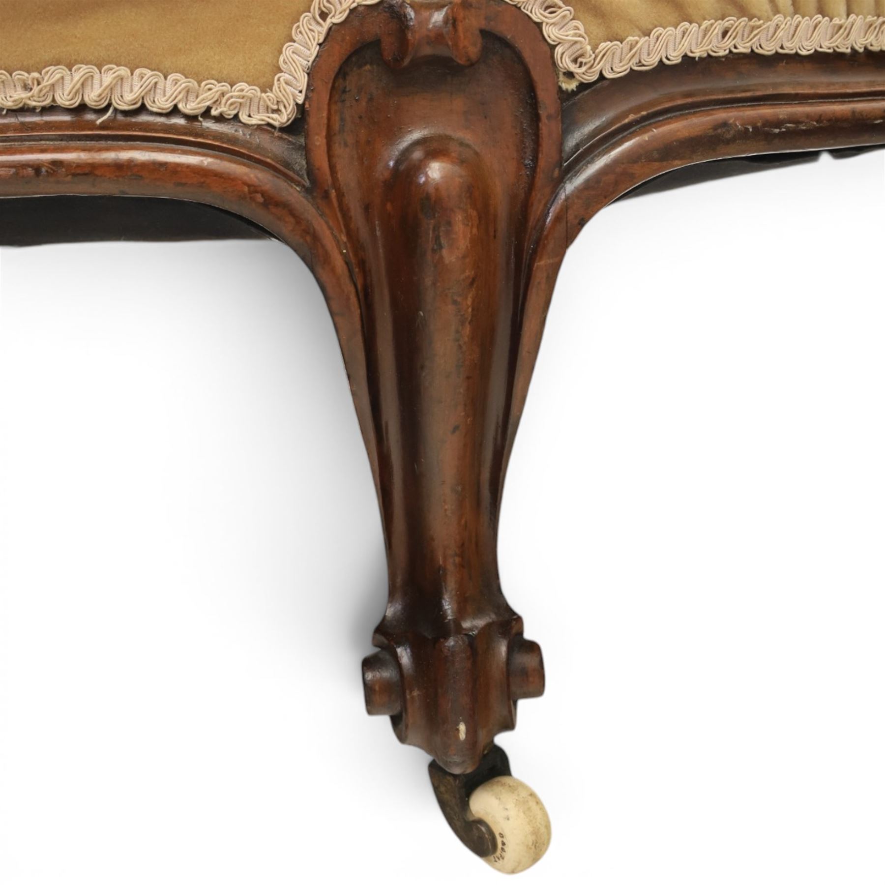 Victorian mahogany chaise lounge, scrolled back rest with deep buttoned back, upholstered in beige velvet, raised on a carved frame raised on cabriole supports terminating in castors 
