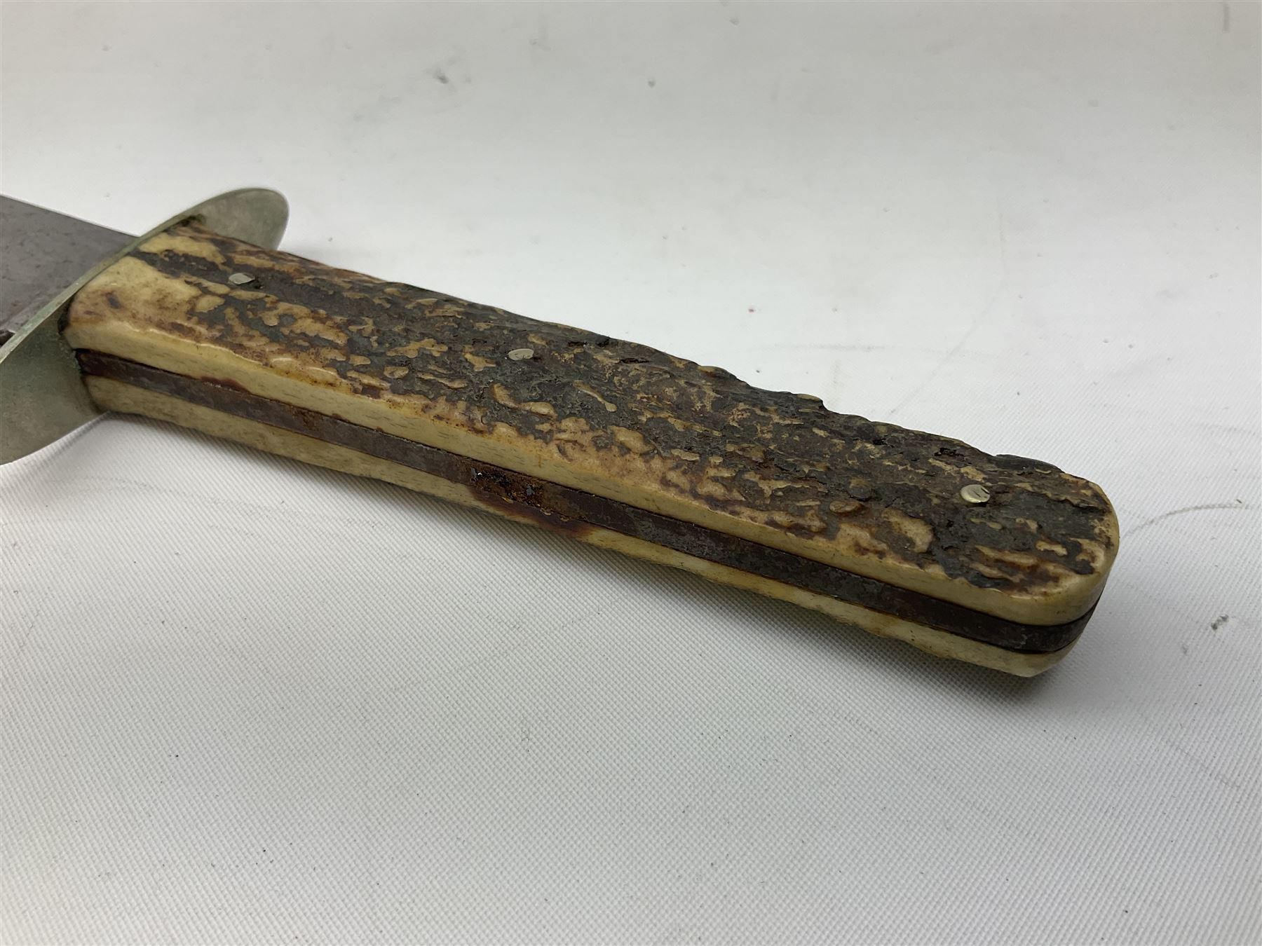 Hunting knife by J Nowill & Sons, Sheffield, the handle inset with mother of pearl, blade length 19cm; George Wolstenholme IXL lock-knife with antler scales L29cm open; and another Bowie style hunting knife marked 'V.R. Warranted Sheffield Joseph Ellis & Sons' in leather sheath (3)