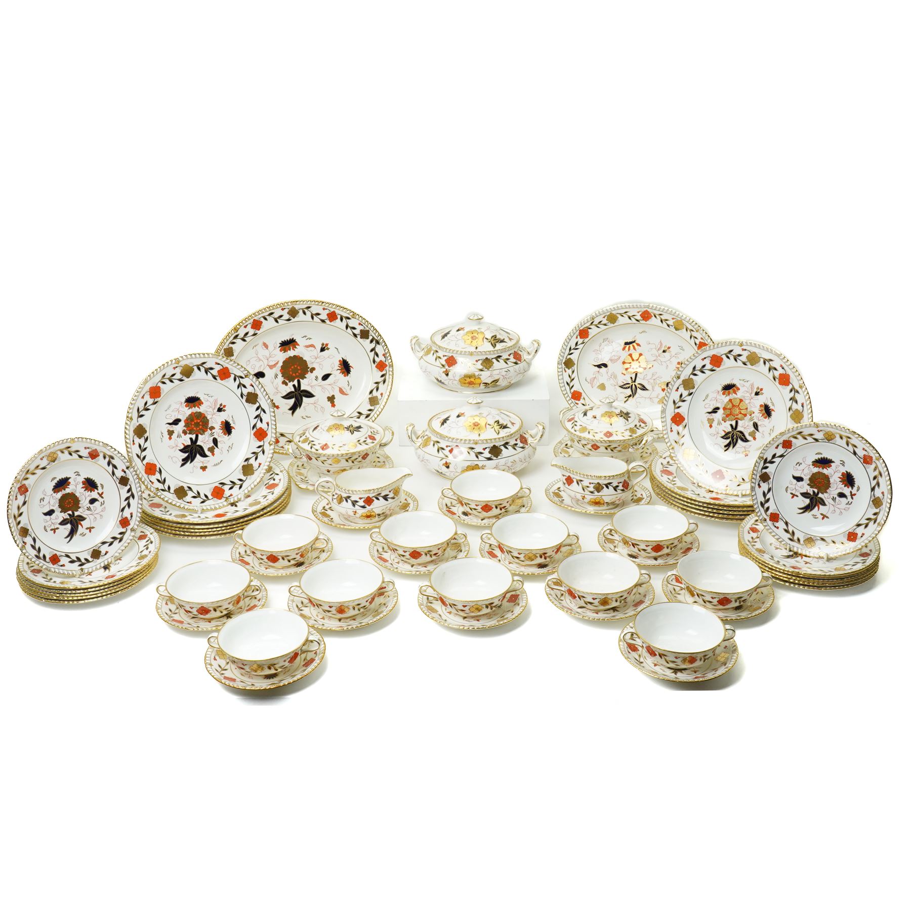 Royal Crown Derby Asian Rose pattern dinner service for twelve covers comprising  twelve dinner plates, twelve dessert plates, twelve two handled soup bowls and stands, pair of sauce boats and stands, pair of sauce tureens with covers and stands, pair of vegetable dishes and covers and two graduated meat plates, date code 1974