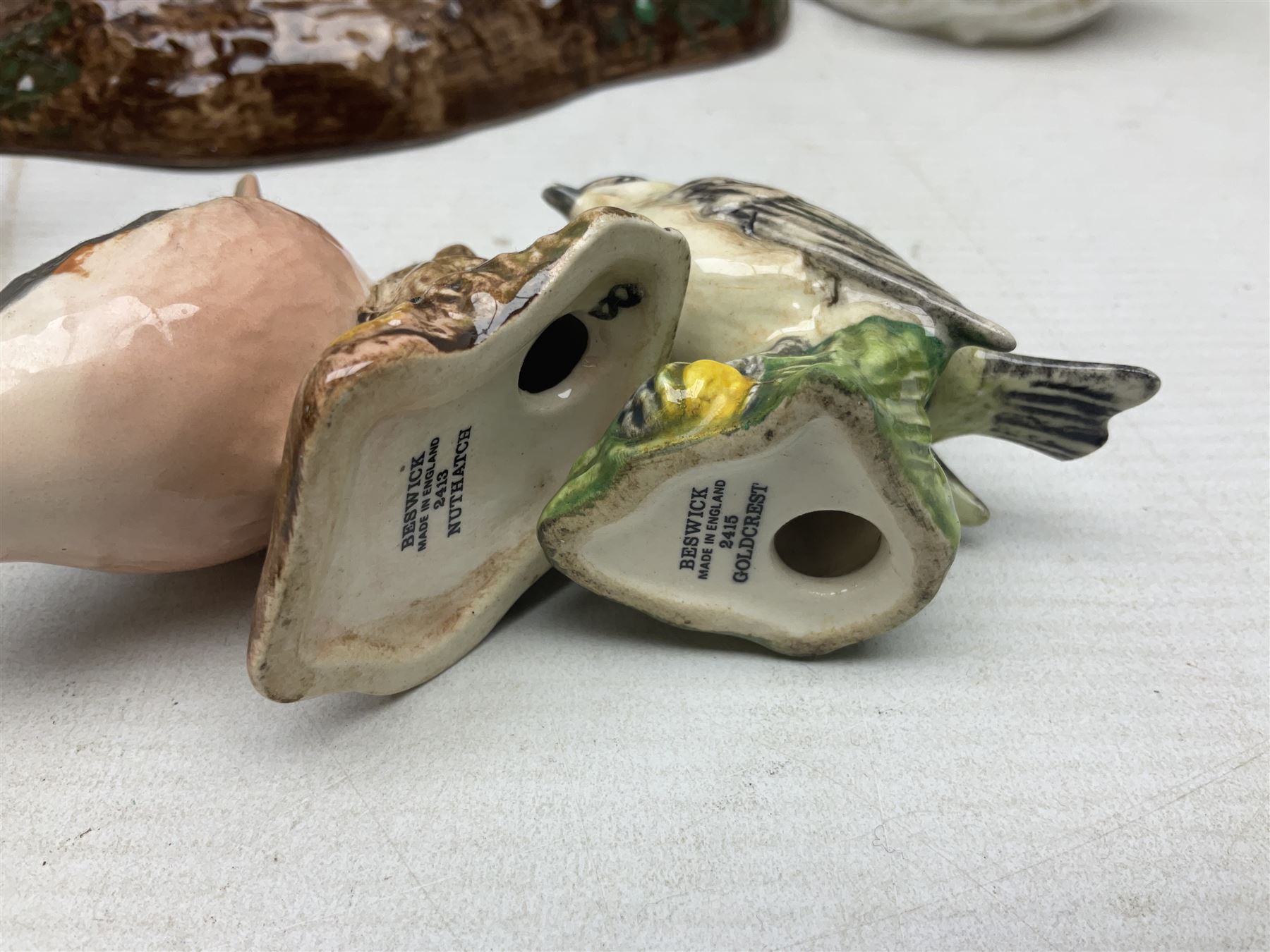 Nine Beswick bird figures, with stand, together with USSR thrush, two Franklin Mint Jane Austin figures and four Royal Doulton figures 